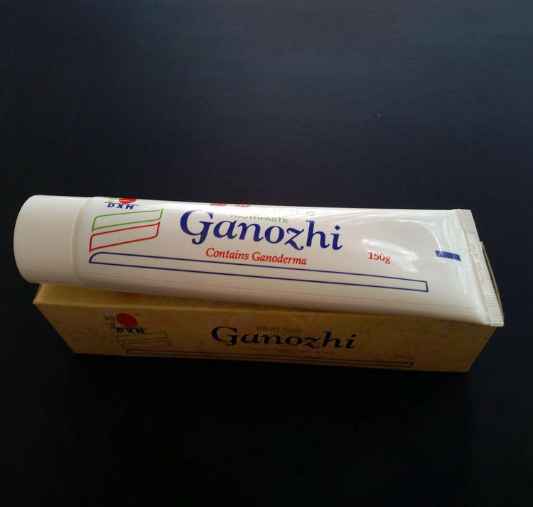 A tube and box of DXN Ganozhi toothpaste containing Ganoderma, a 150g product.
