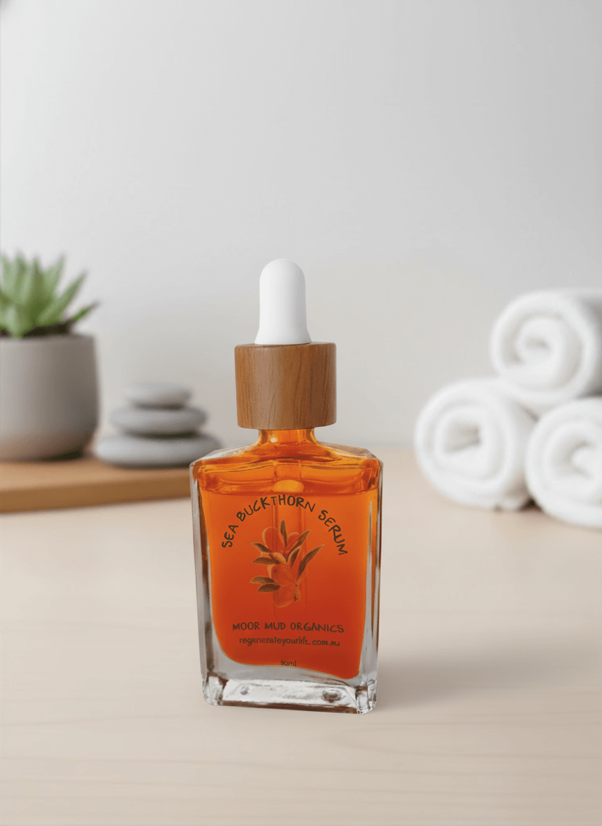 A bottle of Moor Mud Organics Sea Buckthorn Serum in a spa setting with rolled towels.