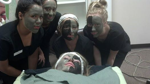 Spa professionals and a client with facial masks on, demonstrating the effectiveness of our clay and mud treatments.
