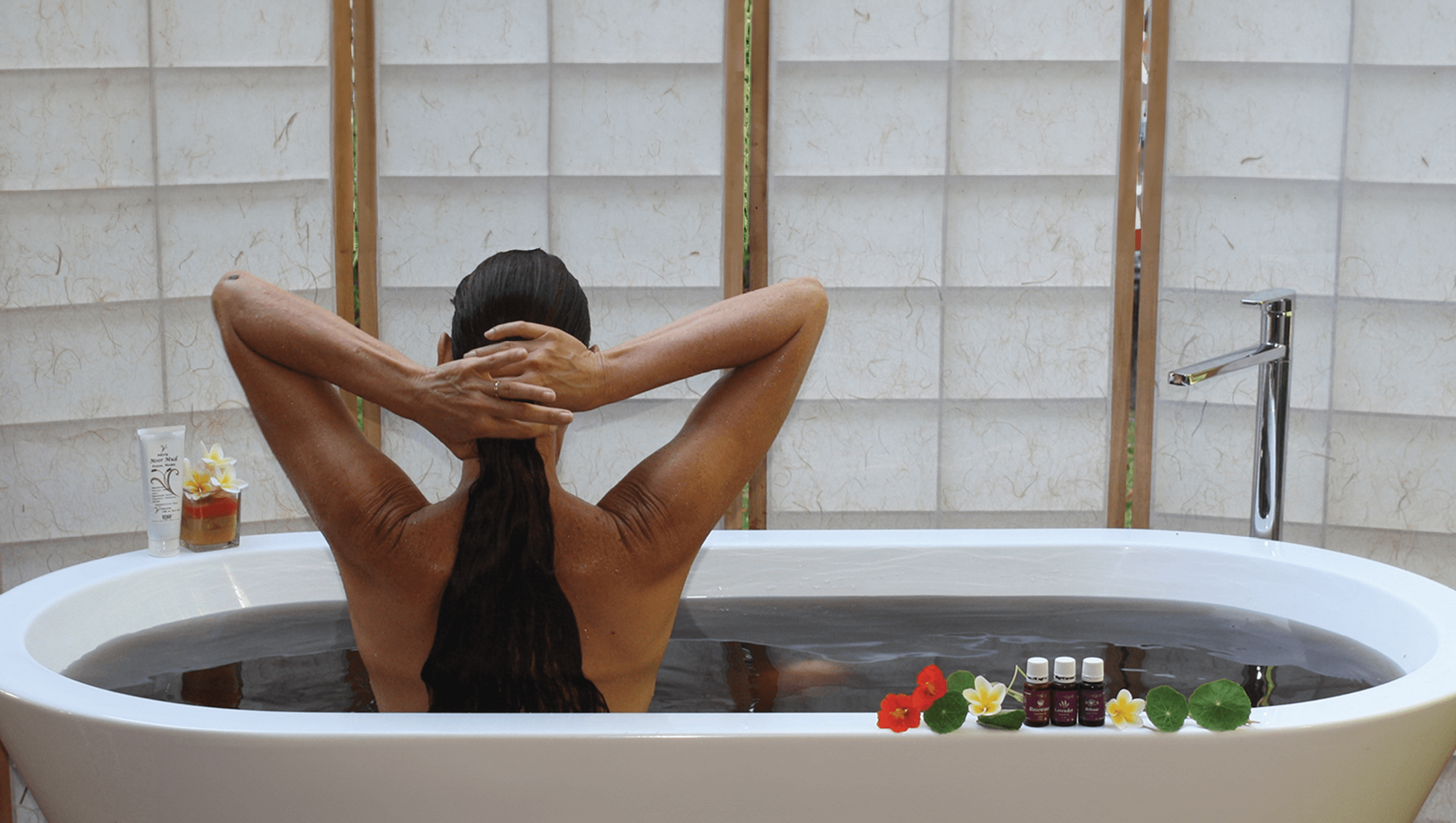 A woman relaxing in a therapeutic Moor Mud bath with essential oils.