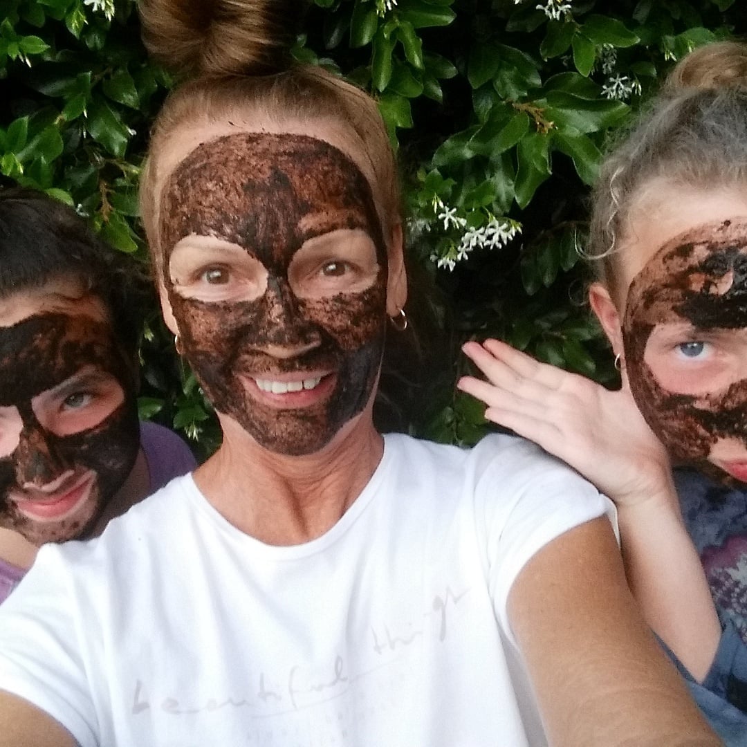 A group of women laughing and wearing Moor mud facial masks for natural skincare and detox.