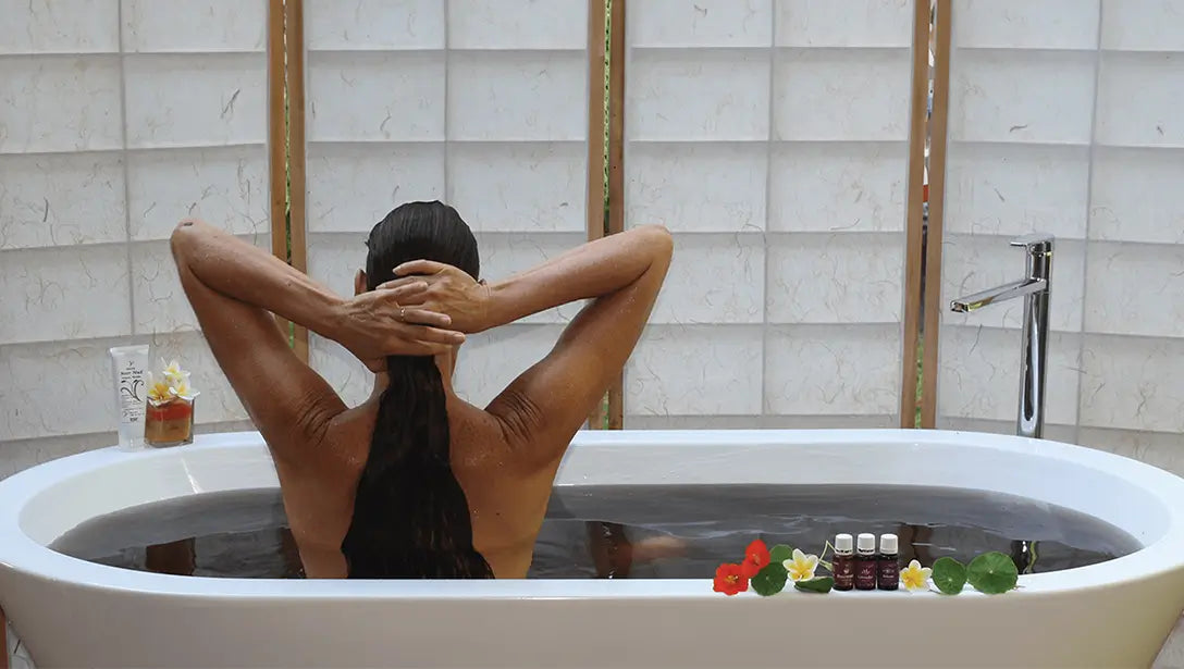A woman relaxing in a therapeutic Moor Mud bath with essential oils.